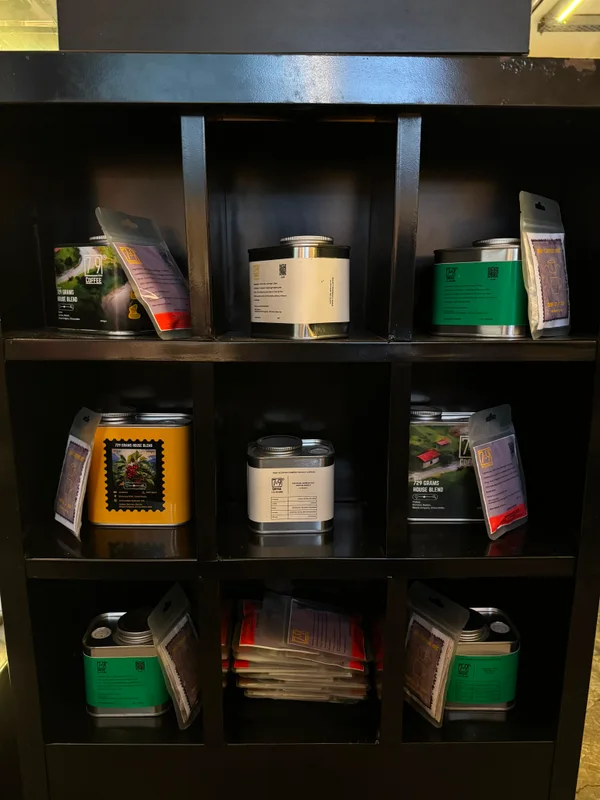 Coffee tins arranged on a café shelf